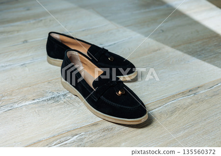Women's black loafers without a heel for every day. Collection of summer women's shoes. Stylish women's shoes for the summer Women's black loafers without a heel for every day. Collection of summer women's shoes. Stylish women's shoes for the summer 135560372