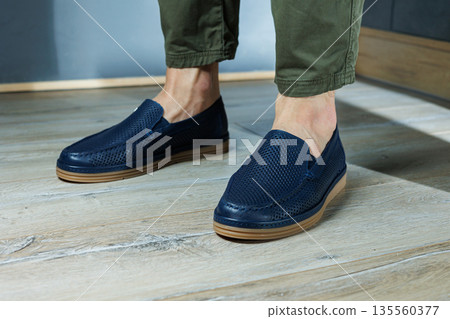 Male legs in blue leather shoes. Men's classic shoes. Male legs in blue leather shoes. Men's classic shoes. 135560377