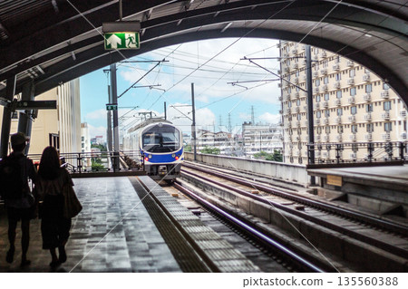 Bangkok Skytrain Airport Raellink electric train arrives at a downtown Bangkok station 135560388