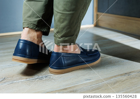 Male legs in blue leather shoes. Men's classic shoes. Male legs in blue leather shoes. Men's classic shoes. 135560428
