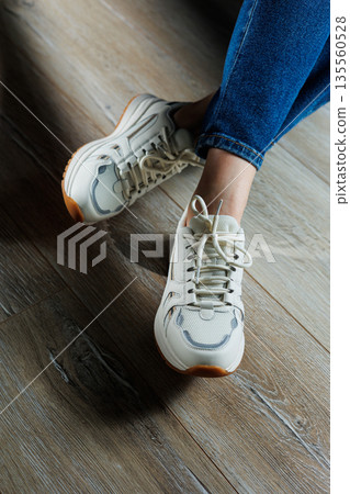 Collection of women's leather shoes. Female legs in leather white casual sneakers. Stylish women's sneakers Collection of women's leather shoes. Female legs in leather white casual sneakers. Stylish women's sneakers 135560528