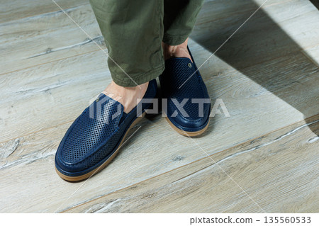 Male legs in blue leather shoes. Men's classic shoes. Male legs in blue leather shoes. Men's classic shoes. 135560533