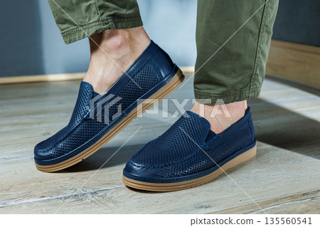 Male legs in blue leather shoes. Men's classic shoes. Male legs in blue leather shoes. Men's classic shoes. 135560541