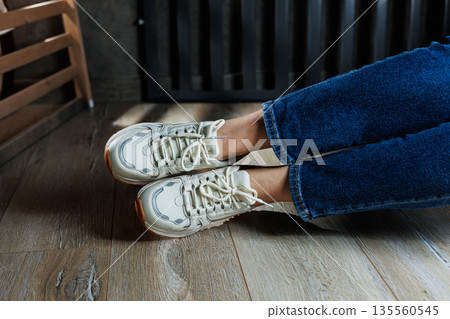 Collection of women's leather shoes. Female legs in leather white casual sneakers. Stylish women's sneakers Collection of women's leather shoes. Female legs in leather white casual sneakers. Stylish women's sneakers 135560545