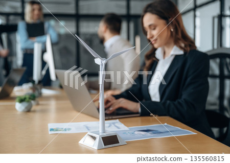 Side view, by the table. Business people are working in the office 135560815