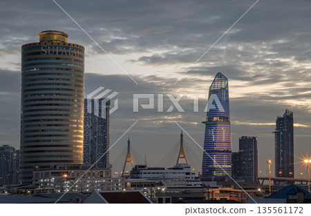 Architectural exterior of Supalai Grand Tower, KingBridge tower and Modern buildings alongside the iconic landmark of Bhumibol Bridge in the beautiful sky background. Architectural exterior of Supalai Grand Tower, KingBridge tower and Modern buildings alongside the iconic landmark of Bhumibol Bridge in the beautiful sky background. 135561172
