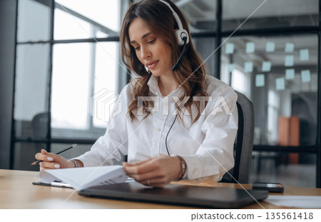 Lot of paperwork. Beautiful woman is in the office Lot of paperwork. Beautiful woman is in the office 135561418