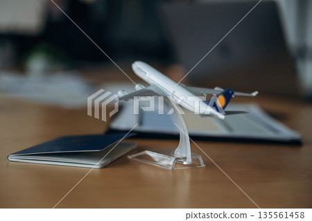 Focused detailed close up view of toy plane and passport Focused detailed close up view of toy plane and passport 135561458