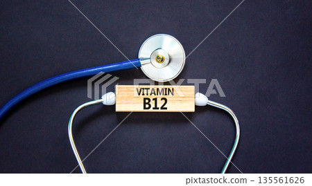 Vitamin B12 symbol. Concept words Vitamin B12 on beautiful wooden block. Stethoscope. Beautiful black background. Medical healthy lifestyle Vitamin B12 concept. Vitamin B12 symbol. Concept words Vitamin B12 on beautiful wooden block. Stethoscope. Beautiful black background. Medical healthy lifestyle Vitamin B12 concept. 135561626