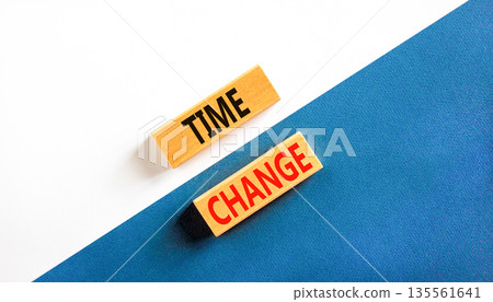 Time change symbol. Concept word Time change on beautiful wooden blocks. Beautiful white and blue paper background. Business time change concept. Copy space. 135561641