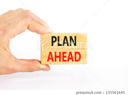 Plan ahead symbol. Concept word Plan ahead on beautiful wooden blocks. Beautiful white paper background. Businessman's hand. Business plan ahead concept. Copy space. Plan ahead symbol. Concept word Plan ahead on beautiful wooden blocks. Beautiful white paper background. Businessman's hand. Business plan ahead concept. Copy space. 135561645