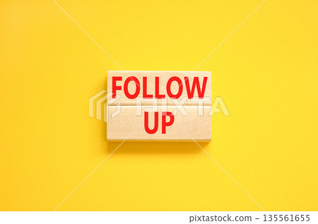 Follow up symbol. Concept word Follow up on beautiful wooden blocks. Beautiful yellow paper background. Business follow up concept. Copy space. Follow up symbol. Concept word Follow up on beautiful wooden blocks. Beautiful yellow paper background. Business follow up concept. Copy space. 135561655