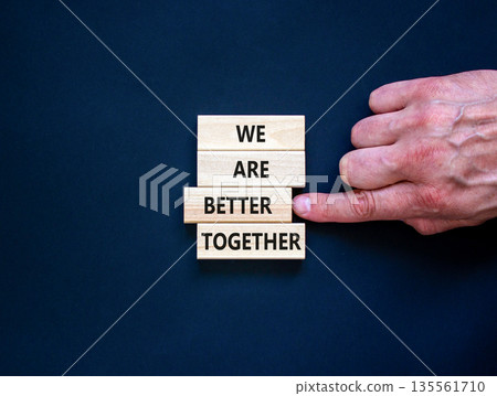 We are better together symbol. Concept words phrase We are better together on beautiful wooden blocks. Beautiful black background. Businessman hand. Business We are better together concept. Copy space 135561710