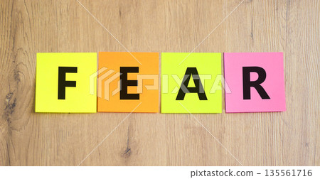 Fear symbol. Concept word Fear on beautiful colored paper. Beautiful wooden table wooden background. Business, lifestyle and fear concept. Copy space. 135561716