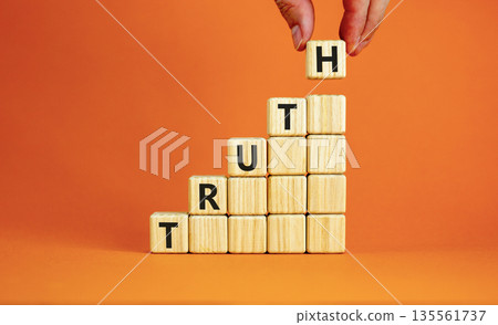 Truth symbol. Concept word Truth on beautiful wooden blocks. Beautiful orange table orange background. Businessman hand. Business lifestyle truth concept. Copy space. 135561737