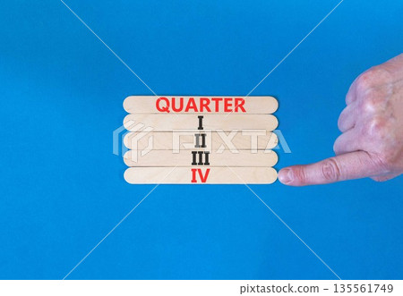 4th fourth quarter 4 symbol. Concept word Quarter 4 on beautiful wooden sticks. Beautiful blue background. Businessman's hand. Business, happy 4th fourth quarter 4 Q4 concept. Copy space. 135561749