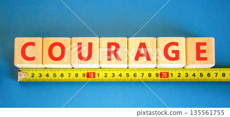 Courage symbol. Concept word Courage on beautiful wooden blocks. Beautiful blue background. Beautiful yellow ruler. Business courage concept. Copy space. Courage symbol. Concept word Courage on beautiful wooden blocks. Beautiful blue background. Beautiful yellow ruler. Business courage concept. Copy space. 135561755