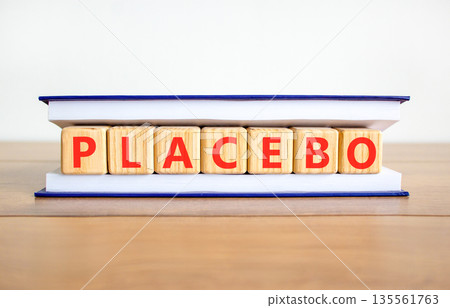 Placebo word medical symbol. Concept word Placebo on beautiful wooden blocks in book. Beautiful wooden table white background. Business placebo word medical concept. Copy space. 135561763