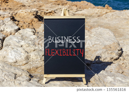 Business flexibility symbol. Concept words Business flexibility on beautiful yellow blackboard. Beautiful red stone beach blue sky sea background. Business flexibility concept. Copy space. Business flexibility symbol. Concept words Business flexibility on beautiful yellow blackboard. Beautiful red stone beach blue sky sea background. Business flexibility concept. Copy space. 135561816