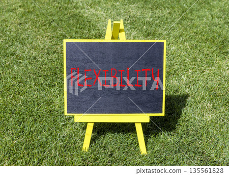 Flexibility symbol. Concept word Flexibility on beautiful black blackboard. Beautiful green grass lawn background. Business flexibility concept. Copy space. Flexibility symbol. Concept word Flexibility on beautiful black blackboard. Beautiful green grass lawn background. Business flexibility concept. Copy space. 135561828