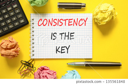 Consistency is the key symbol. Concept words Consistency is the key on beautiful white note. Beautiful yellow background. Black pen. Business consistency is the key concept. Copy space. 135561848
