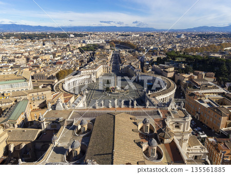 Panoramic view of Vatican City and Rome from St. Peter's Basilica dome offering an expansive. St. Peter's Square Rome panoramic cityscape. View from dome of St. Peters Basilica. Popular tourist place. Panoramic view of Vatican City and Rome from St. Peter's Basilica dome offering an expansive. St. Peter's Square Rome panoramic cityscape. View from dome of St. Peters Basilica. Popular tourist place. 135561885