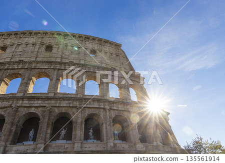 Famous Coliseum in Rome. Colosseum, or Coliseum. Sunset at huge Roman amphitheatre, Rome, Italy, Europe. Famous touristic place in the world and Europe. Beautiful blue sky background. Famous Coliseum in Rome. Colosseum, or Coliseum. Sunset at huge Roman amphitheatre, Rome, Italy, Europe. Famous touristic place in the world and Europe. Beautiful blue sky background. 135561914