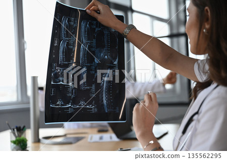 X-ray in hands. Two doctors are in the office X-ray in hands. Two doctors are in the office 135562295