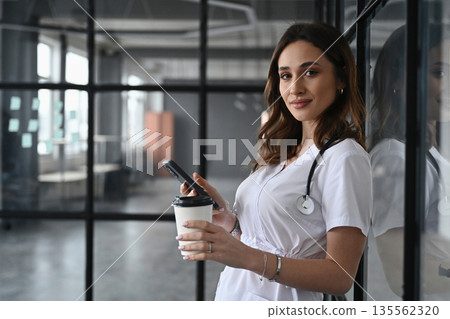 Coffee break, with cup. Woman doctor is in the office 135562320