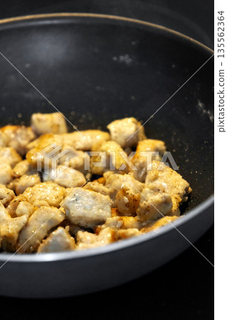 chicken pieces fried in frying pan chicken pieces fried in frying pan 135562364