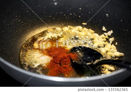 Sweet and sour sauce cooking in frying pan 135562365