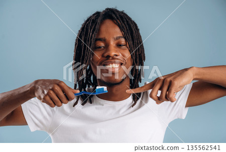 Stomatology, oral hygiene. Black man is in the studio against soft background 135562541