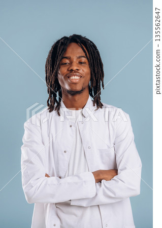 Doctor with stethoscope. Black man is in the studio against soft background Doctor with stethoscope. Black man is in the studio against soft background 135562647
