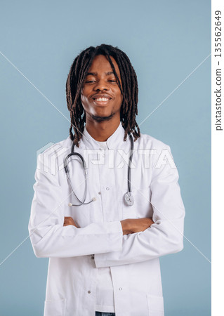 Doctor with stethoscope. Black man is in the studio against soft background Doctor with stethoscope. Black man is in the studio against soft background 135562649