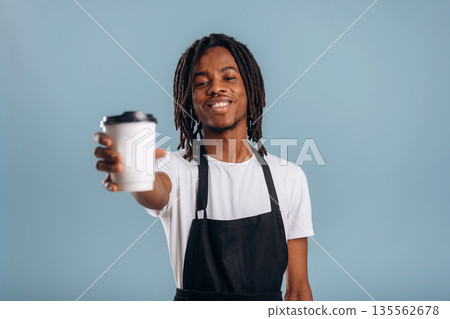 Barista is with coffee. Black man is in the studio against soft background 135562678