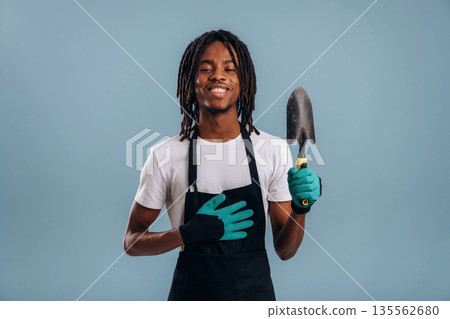 Gardener is ready to work. Black man is in the studio against soft background 135562680