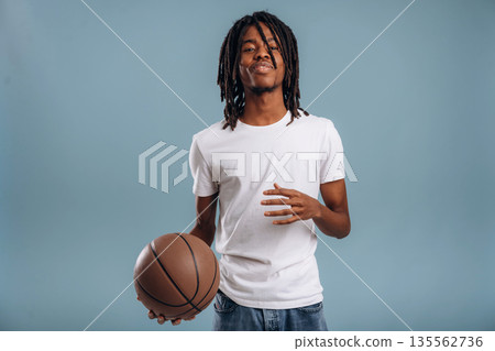 Basketball player. Black man is in the studio against soft background 135562736