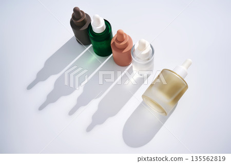 Skincare serum dropper bottles in minimalist shadow display 135562819