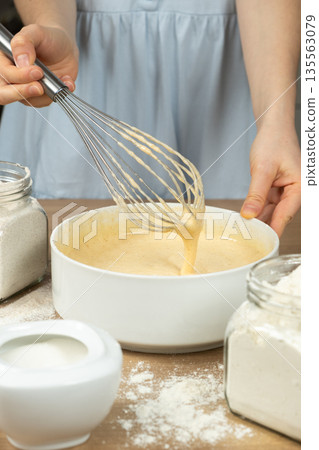Texture of batter for baking, dough dripping from whisk close-up. Texture of batter for baking, dough dripping from whisk close-up. 135563079
