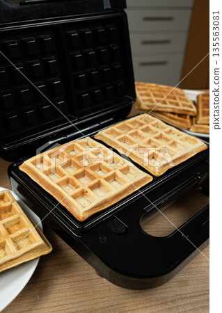 Homemade Belgian Waffles Ready to Be Served, Still in the Waffle Iron Homemade Belgian Waffles Ready to Be Served, Still in the Waffle Iron 135563081