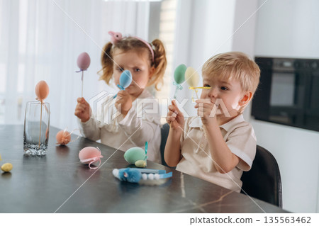 Easter conception. Kids are preparing bakery at home Easter conception. Kids are preparing bakery at home 135563462