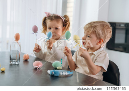 Easter conception. Kids are preparing bakery at home Easter conception. Kids are preparing bakery at home 135563463