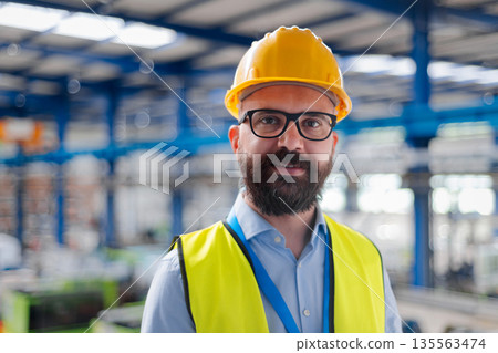Portrait of handsome warehouse manager with safety helmet. Portrait of handsome warehouse manager with safety helmet. 135563474