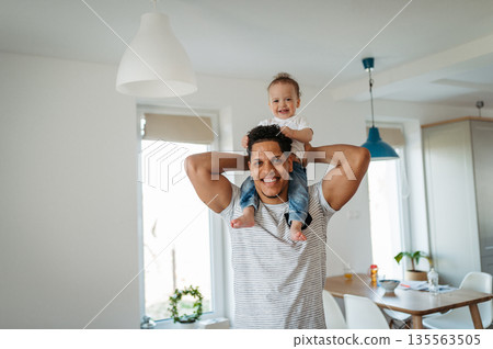Father and small toddler son. Dad hodling and kissing boy. 135563505
