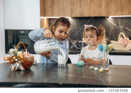 At kitchen, Easter eggs. Two little girls are preparing bakery at home At kitchen, Easter eggs. Two little girls are preparing bakery at home 135563506