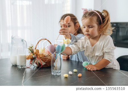 At kitchen, Easter eggs. Two little girls are preparing bakery at home At kitchen, Easter eggs. Two little girls are preparing bakery at home 135563510