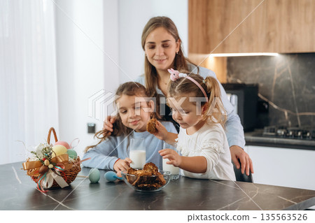 Preparing bakery. Mother with her little daughters at home Preparing bakery. Mother with her little daughters at home 135563526