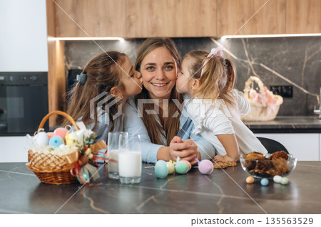Mother with her little daughters preparing bakery Mother with her little daughters preparing bakery 135563529