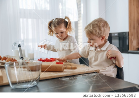 Red bakeware. Kids are preparing bakery at home 135563598