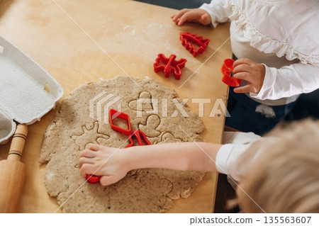 Using bakeware. Kids are preparing bakery at home Using bakeware. Kids are preparing bakery at home 135563607